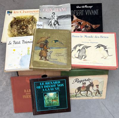 several books are stacked on top of each other on the floor