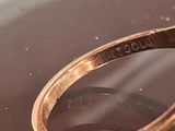 a close up of a gold ring with a diamond on it