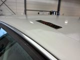 a sticker on the roof of a car that is parked in a garage