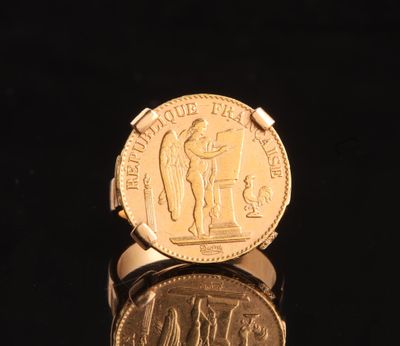 a gold coin sitting on top of a black surface