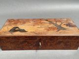 an image of a wooden box with a painting on it