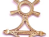 a close up of a gold pendant with a cross on it