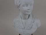 white marble bust of a young boy on a black and gold base