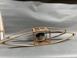 a small wooden boat with a pen on top of it