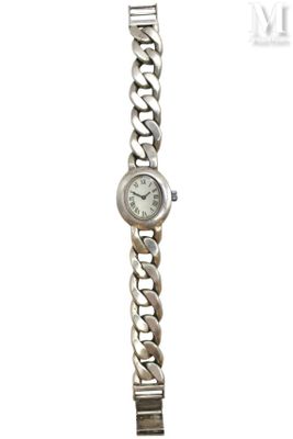 an image of a woman ' s wrist watch with a chain around it