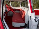 a red and white car with a red seat cover and steering wheel
