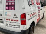 a white van that is parked in a parking lot