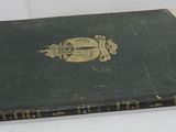 an old book sitting on a table in a room