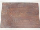a wooden cutting board on the floor of a kitchen