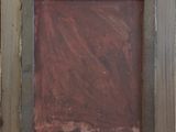 an old picture frame sitting on top of a wooden table