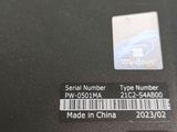 a sticker on the back of a laptop with a barcode on it