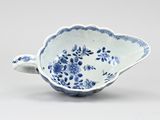 blue and white porcelain bowl with a flower design on the rim
