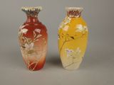 two vases sitting side by side on a gray surface