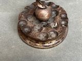 a metal object with a spiral design on top of it