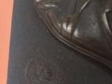 a statue of a shoe that is on top of a book