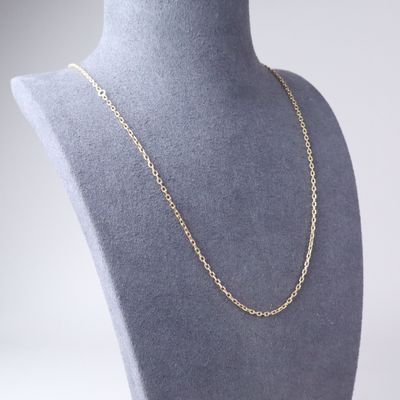 a close up of a mannequin with a gold chain on it