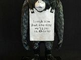 statue of a monkey holding a sign with a sign on it ' s head