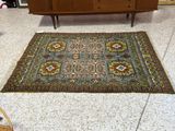a rug on the floor next to a cabinet