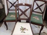 four antique chairs with green cushions and a floral design on them