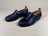 a pair of blue leather loafers with a wooden heel