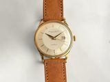 a watch that is sitting on a white surface