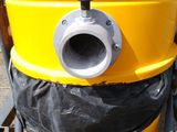 a yellow dust collector with a black bag on top of it