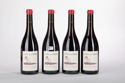 three bottles of wine are lined up on a white surface
