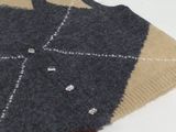 a sweater on a table with a cup of coffee on it