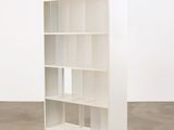 an image of a white bookcase in an empty room