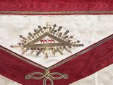 a close up of a red and white apron with a cross on it