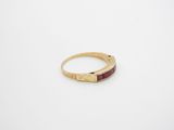 a gold ring with a red stone in the middle
