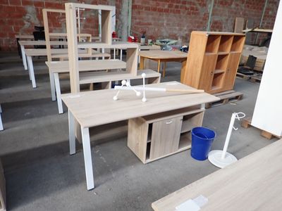 many tables and chairs in a room with a brick wall
