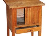 a small wooden table with a drawer on it