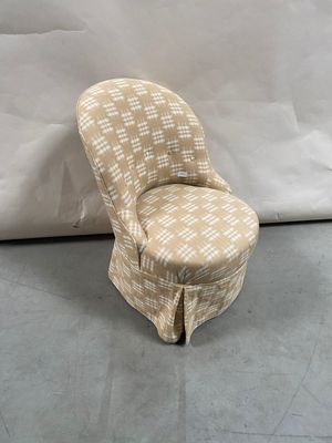 an upholstered chair with a checkered upholstered seat
