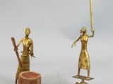two figurines of a woman with a sword and a man with a hat