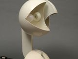 a white lamp that has a face on the top of it