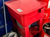 a red table with a red bucket on top of it