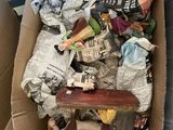 a cardboard box filled with assorted items in the back of a car