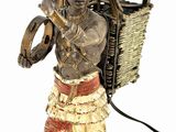 statue of a man carrying a basket with a bird on his shoulder