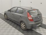 a grey car parked in a garage with a checkered floor
