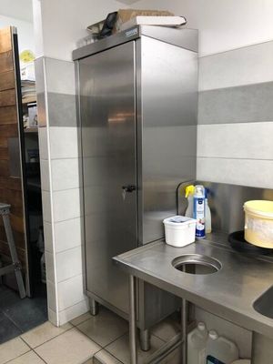 a kitchen with a sink and a refrigerator in it