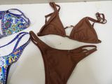 a brown bikini and a blue bikinisuit on a table