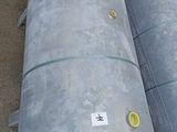 two metal tanks sitting next to each other on the ground