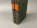 an old book sitting on top of a table next to a gray background
