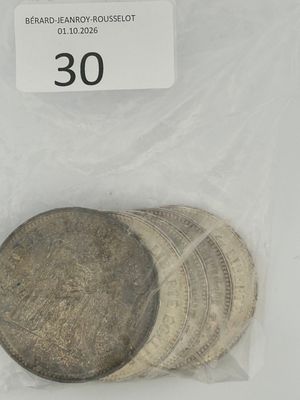 three silver coins in a plastic bag with a price tag