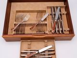 a wooden box with a set of silverware in it