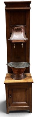 a wooden cabinet with a metal bowl on top of it