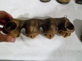 a person holding a piece of wood that looks like three elephants