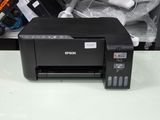 a printer that is sitting on a table next to other items