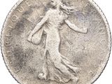 a close up of a coin with a woman on it